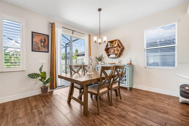 4808 Jackson Club Loop, Tampa, FL 33624 - dining room with wood finished floors and a chandelier