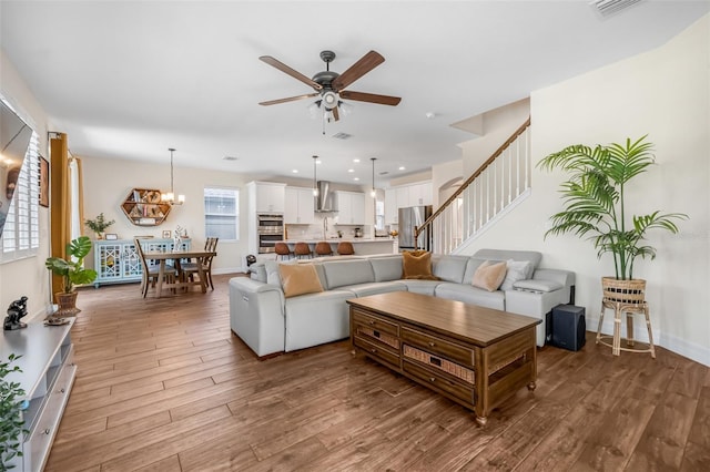 4808 Jackson Club Loop, Tampa, FL 33624 - living room with wood finished floors, ceiling fan, stairway, a chandelier, and recessed lighting