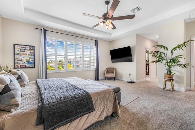 4808 Jackson Club Loop, Tampa, FL 33624 - bedroom with carpet, a tray ceiling, and a ceiling fan