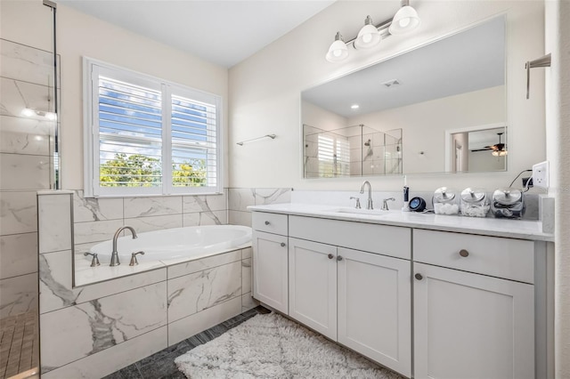 4808 Jackson Club Loop, Tampa, FL 33624 - bathroom with vanity, a bath, and a tile shower