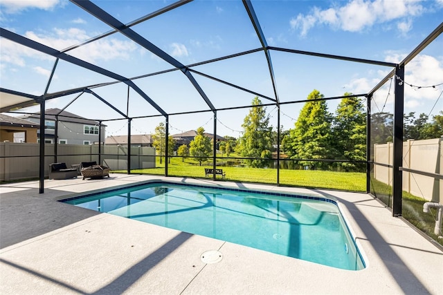 4808 Jackson Club Loop, Tampa, FL 33624 - view of swimming pool featuring a patio, a fire pit, and glass enclosure