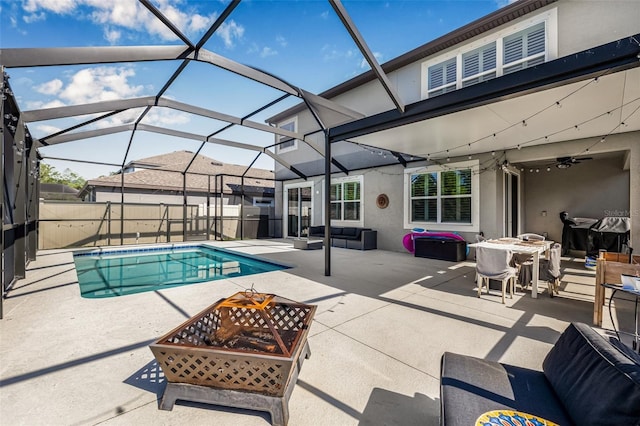 4808 Jackson Club Loop, Tampa, FL 33624 - view of swimming pool with a fire pit, a patio, ceiling fan, and a lanai