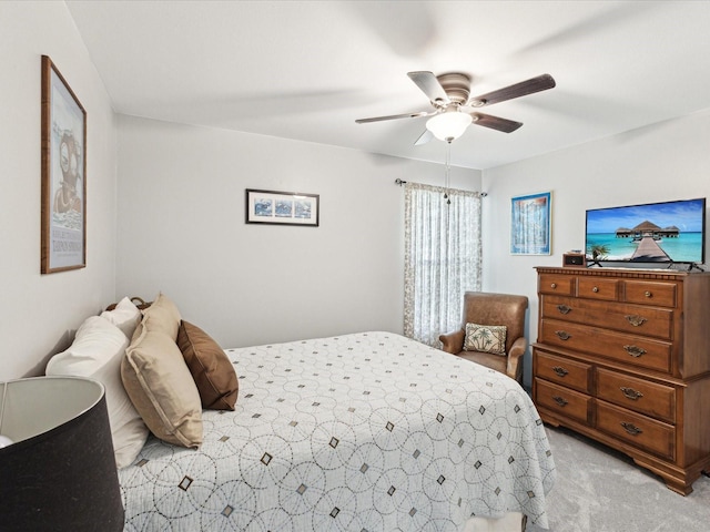 bedroom with light colored carpet and a ceiling fan