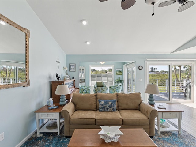 living room featuring ceiling fan, vaulted ceiling, and a wealth of natural light