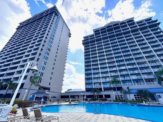 13415 Blue Heron Beach Dr Unit 1006, Orlando, FL 32821 - community pool featuring a patio