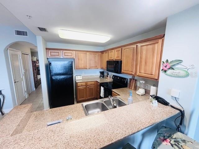 13415 Blue Heron Beach Dr Unit 1006, Orlando, FL 32821 - kitchen with a sink, arched walkways, black appliances, and visible vents