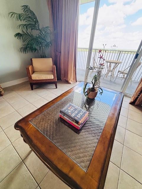13415 Blue Heron Beach Dr Unit 1006, Orlando, FL 32821 - living area with tile patterned floors and baseboards