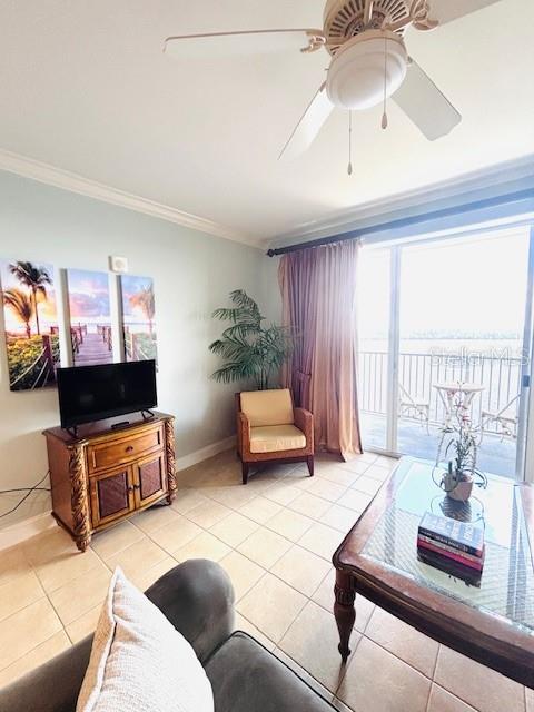 13415 Blue Heron Beach Dr Unit 1006, Orlando, FL 32821 - living area featuring baseboards, ornamental molding, ceiling fan, and light tile patterned flooring
