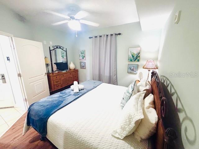 13415 Blue Heron Beach Dr Unit 1006, Orlando, FL 32821 - bedroom featuring ceiling fan and wood finished floors