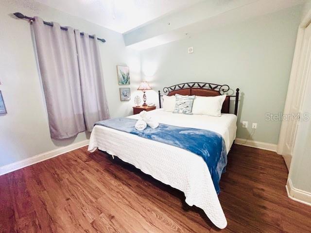 13415 Blue Heron Beach Dr Unit 1006, Orlando, FL 32821 - bedroom featuring baseboards and wood finished floors