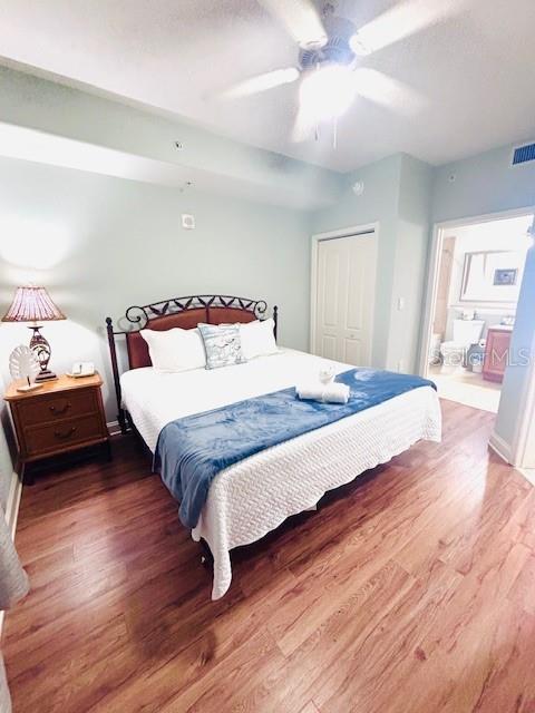 13415 Blue Heron Beach Dr Unit 1006, Orlando, FL 32821 - bedroom with a ceiling fan, visible vents, wood finished floors, and a closet