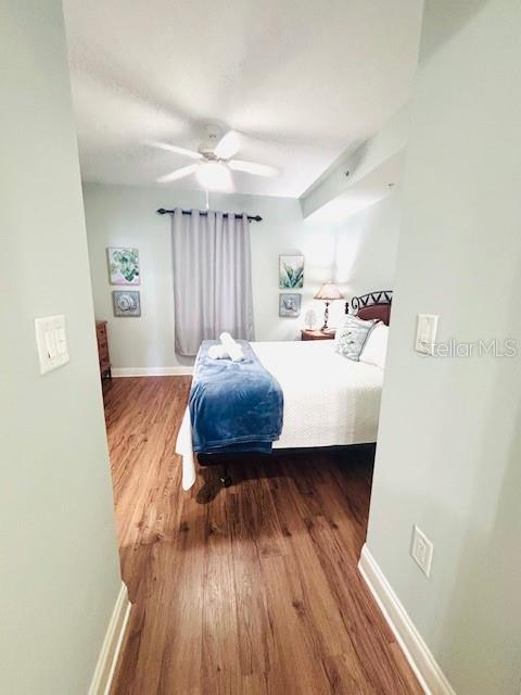 13415 Blue Heron Beach Dr Unit 1006, Orlando, FL 32821 - bedroom featuring baseboards, ceiling fan, and wood finished floors