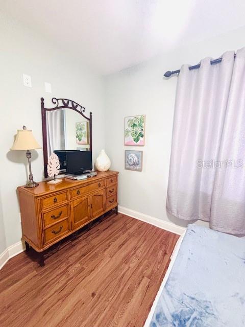 13415 Blue Heron Beach Dr Unit 1006, Orlando, FL 32821 - bedroom with baseboards and light wood-style flooring