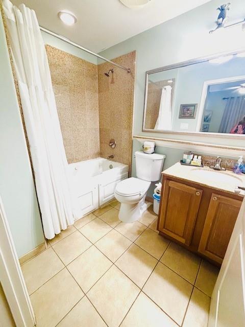 13415 Blue Heron Beach Dr Unit 1006, Orlando, FL 32821 - bathroom featuring tile patterned floors, vanity, toilet, and shower / tub combo