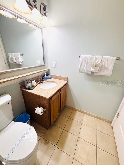 13415 Blue Heron Beach Dr Unit 1006, Orlando, FL 32821 - half bathroom with tile patterned flooring, toilet, and vanity