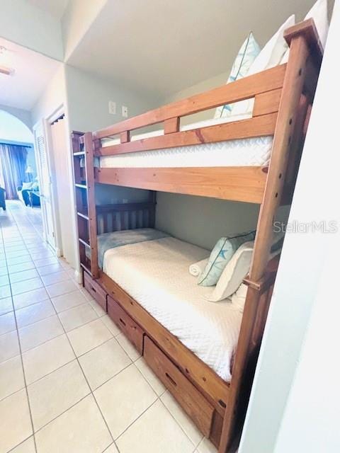 13415 Blue Heron Beach Dr Unit 1006, Orlando, FL 32821 - bedroom featuring light tile patterned flooring and vaulted ceiling