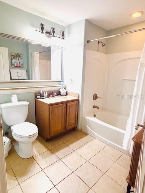 13415 Blue Heron Beach Dr Unit 1006, Orlando, FL 32821 - bathroom with tile patterned flooring, shower / bath combination with curtain, toilet, and vanity