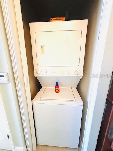 13415 Blue Heron Beach Dr Unit 1006, Orlando, FL 32821 - clothes washing area featuring stacked washer and clothes dryer and laundry area