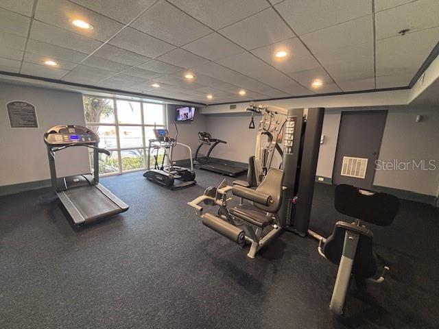 13415 Blue Heron Beach Dr Unit 1006, Orlando, FL 32821 - exercise room featuring baseboards, recessed lighting, a paneled ceiling, and visible vents