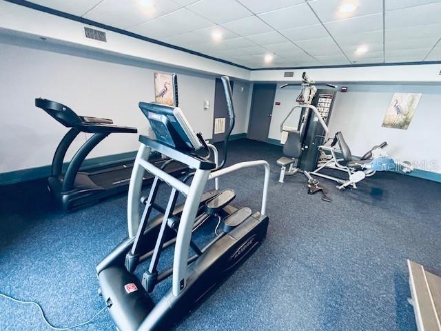13415 Blue Heron Beach Dr Unit 1006, Orlando, FL 32821 - gym with baseboards, visible vents, and a paneled ceiling