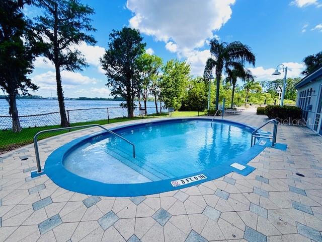 13415 Blue Heron Beach Dr Unit 1006, Orlando, FL 32821 - pool with a water view, a patio area, and fence