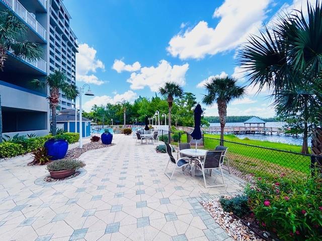 13415 Blue Heron Beach Dr Unit 1006, Orlando, FL 32821 - view of property's community featuring fence, a water view, and a patio area