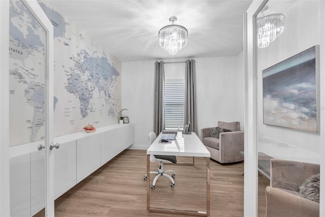 office featuring light wood finished floors and a chandelier