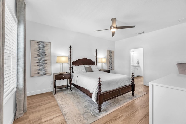 bedroom with visible vents, baseboards, ensuite bathroom, ceiling fan, and light wood-style flooring
