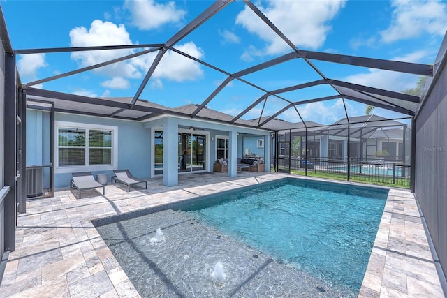 outdoor pool with glass enclosure, ceiling fan, and a patio area