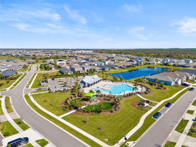 birds eye view of property with a water view and a residential view