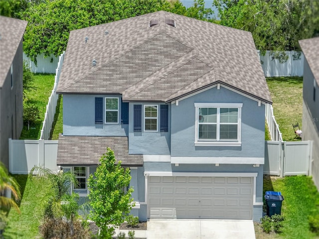 413 Royal Empress Dr, Ruskin, FL 33570 - view of front facade featuring stucco siding, concrete driveway, a fenced backyard, and a garage