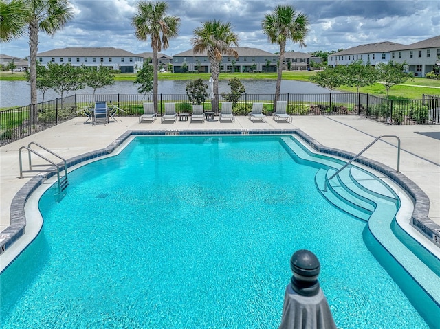 413 Royal Empress Dr, Ruskin, FL 33570 - community pool featuring a patio area, fence, a residential view, and a water view