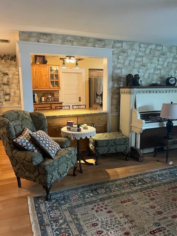 living area featuring visible vents and light wood-type flooring