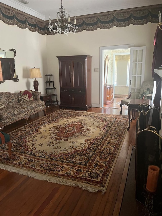 interior space with crown molding, visible vents, hardwood / wood-style floors, and a notable chandelier