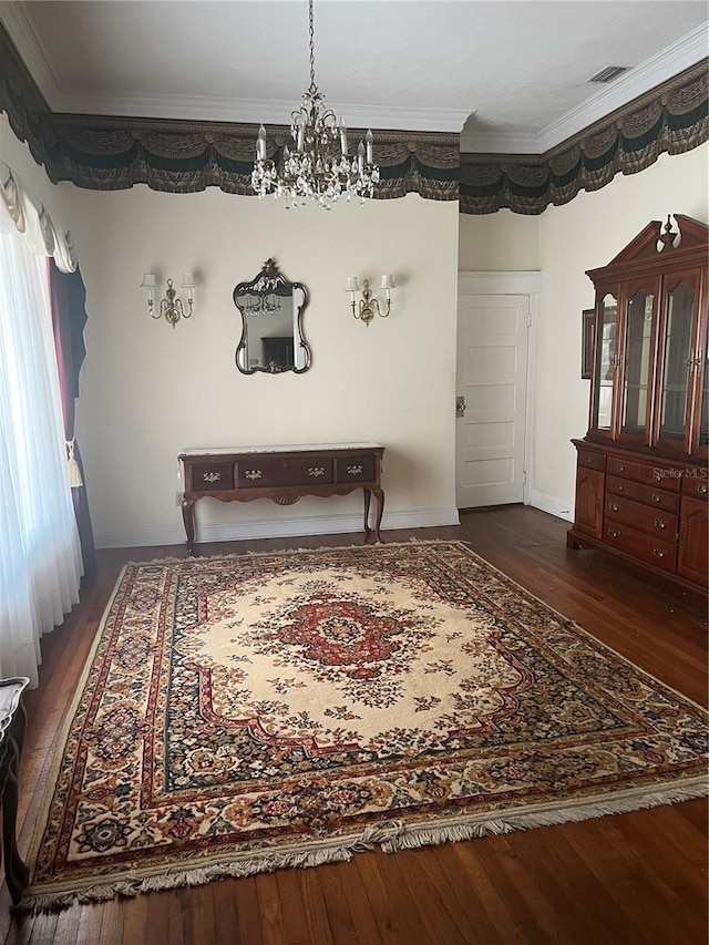 dining area with visible vents, ornamental molding, dark wood finished floors, and a chandelier
