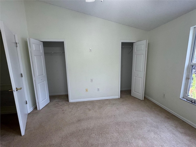 6405 Osprey Lake Cir, Riverview, FL 33578 - unfurnished bedroom featuring two closets, carpet flooring, vaulted ceiling, and baseboards