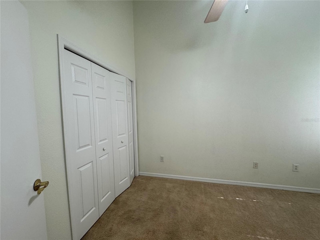 6405 Osprey Lake Cir, Riverview, FL 33578 - unfurnished bedroom with a closet, baseboards, a ceiling fan, and carpet flooring