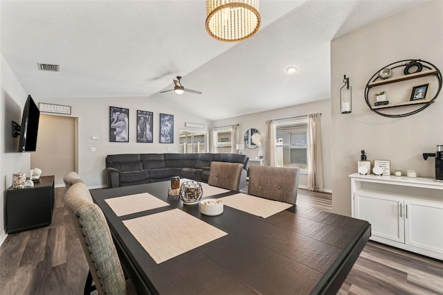 518 Royal Ridge St, Valrico, FL 33594 - dining room with ceiling fan with notable chandelier, lofted ceiling, dark wood finished floors, and visible vents