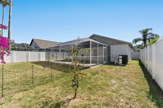 518 Royal Ridge St, Valrico, FL 33594 - view of yard with a fenced backyard, central air condition unit, a patio area, and glass enclosure