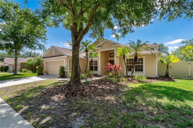 8211 Canyon Creek Way, Tampa, FL 33647 - ranch-style home with fence, an attached garage, a front lawn, stucco siding, and driveway
