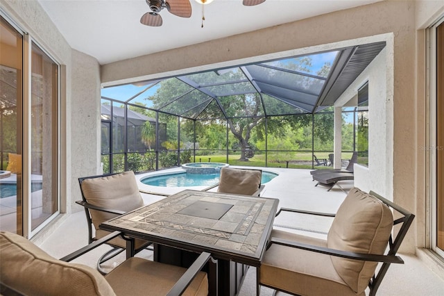 view of patio featuring glass enclosure, ceiling fan, a pool with connected hot tub, and outdoor dining space