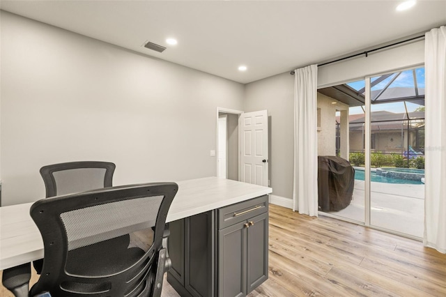 home office with recessed lighting, light wood finished floors, baseboards, and visible vents