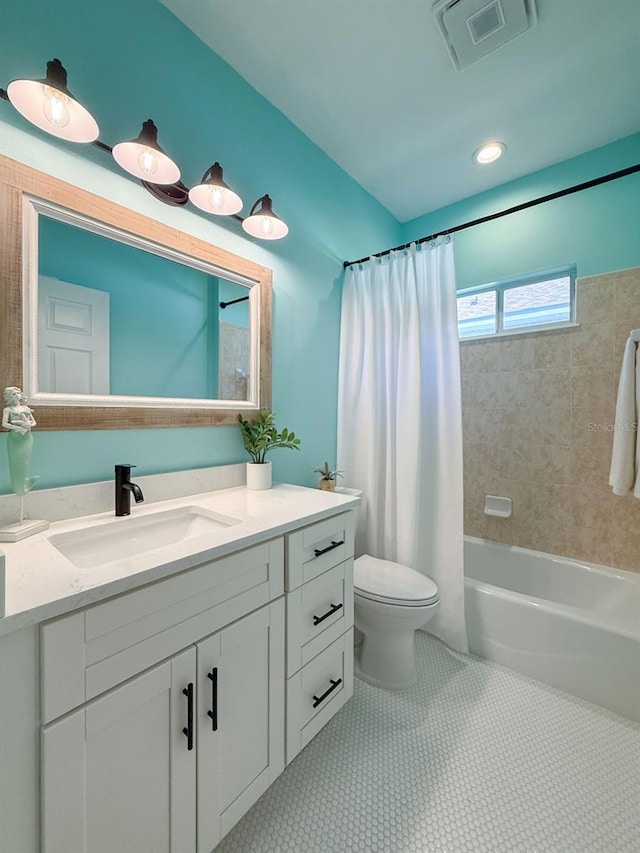 bathroom featuring visible vents, vanity, toilet, tile patterned floors, and shower / bath combo