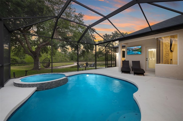 view of swimming pool with glass enclosure, a patio area, and a pool with connected hot tub