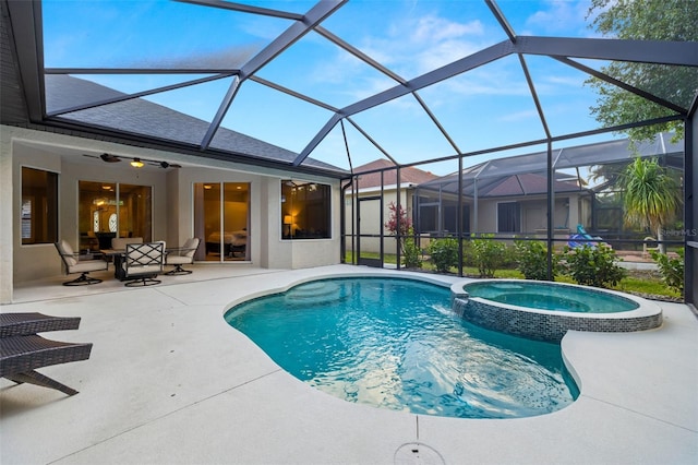 view of pool featuring a lanai, ceiling fan, a pool with connected hot tub, and a patio area