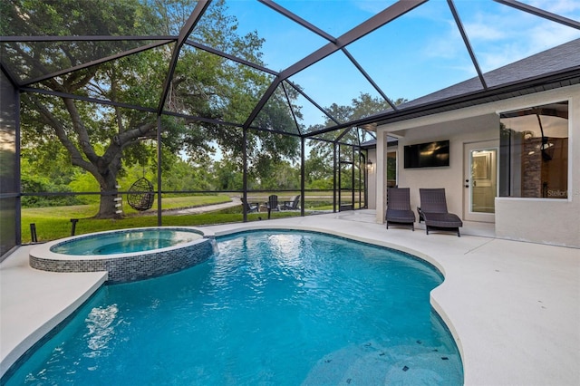 view of swimming pool featuring a pool with connected hot tub, a lanai, and a patio area