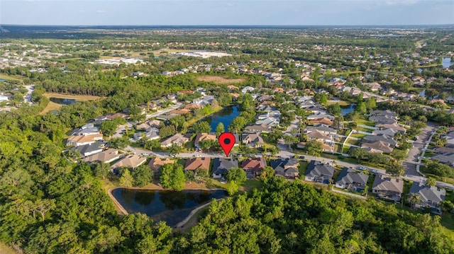 drone / aerial view featuring a residential view and a water view