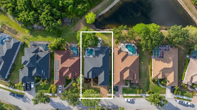 drone / aerial view with a residential view and a water view