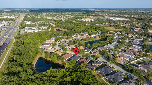 drone / aerial view with a water view and a residential view