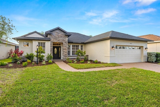 view of front facade featuring a front yard, an attached garage, driveway, and stone siding